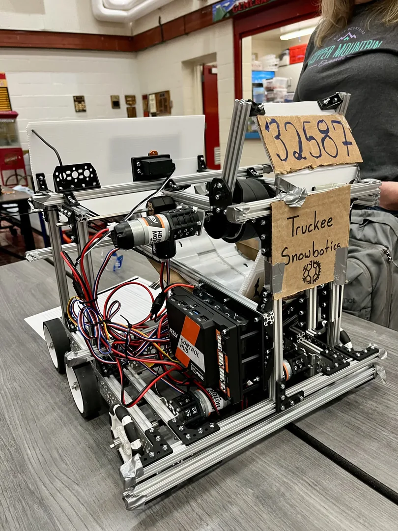 A student working on a robot prototype at a workbench