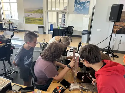 Team members working together on the robot at a build session.