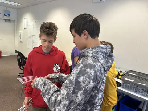 Two team members examining a part during a build session.